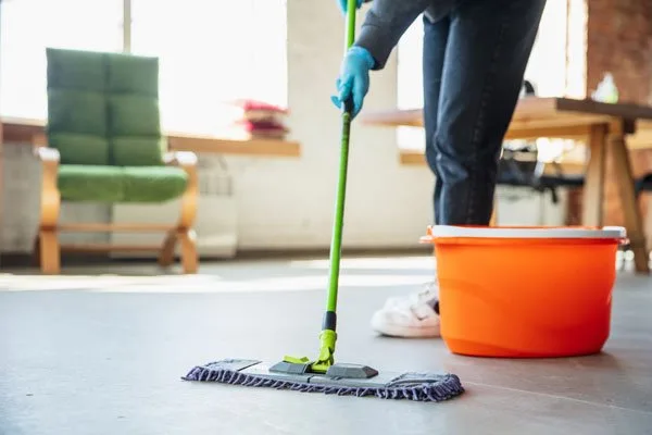 Mopping the floor in a bright living room