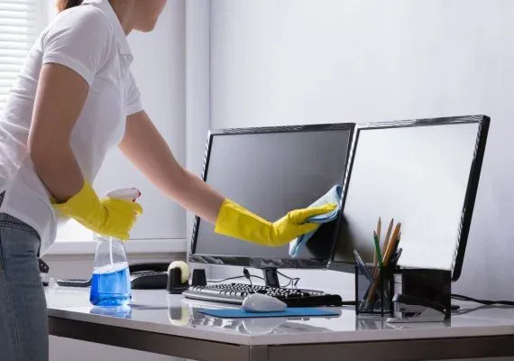 Cleaning an office desk and workspace